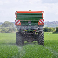 Tractor spreading fertiliser